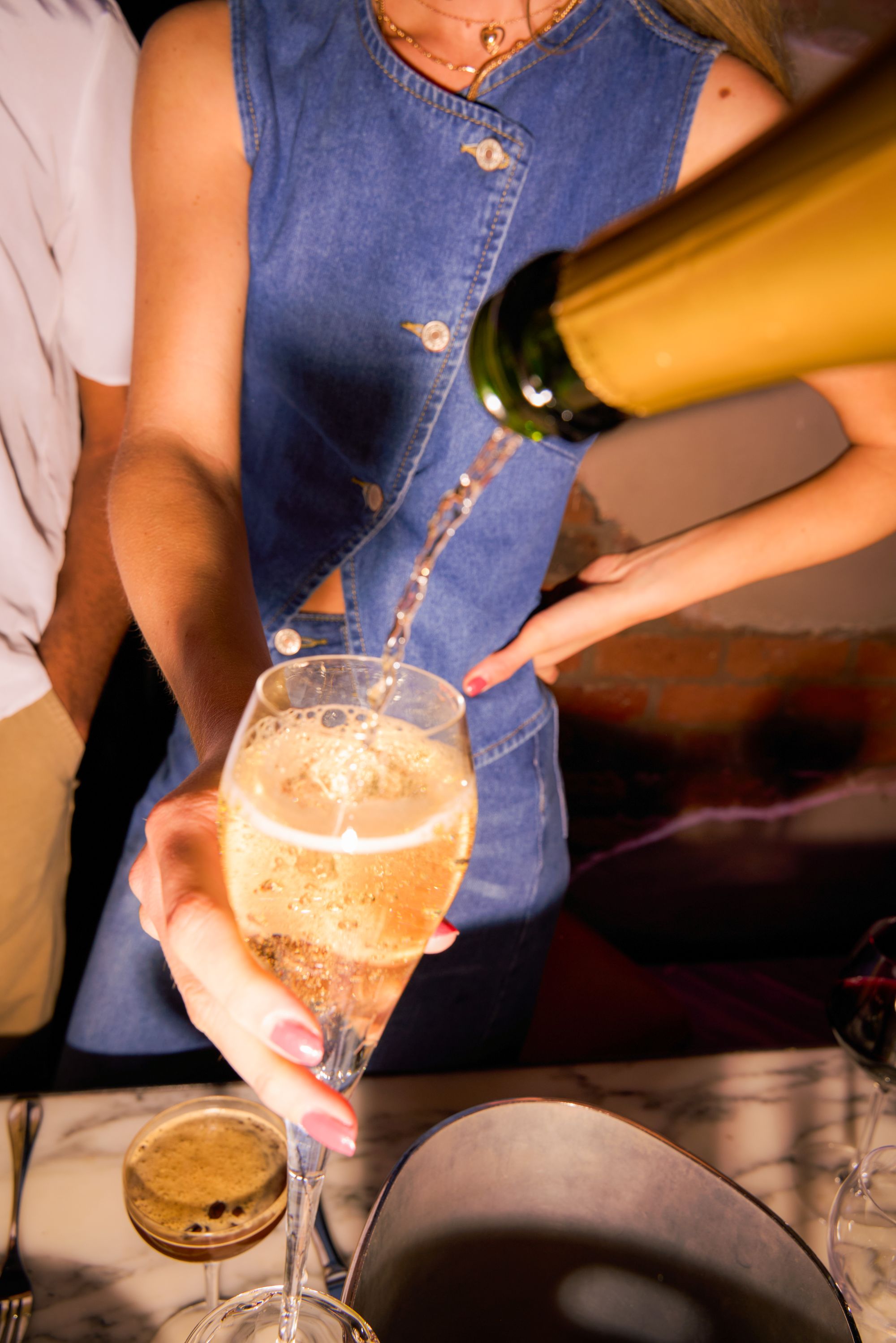 Champagne being poured at the bar during a celebration